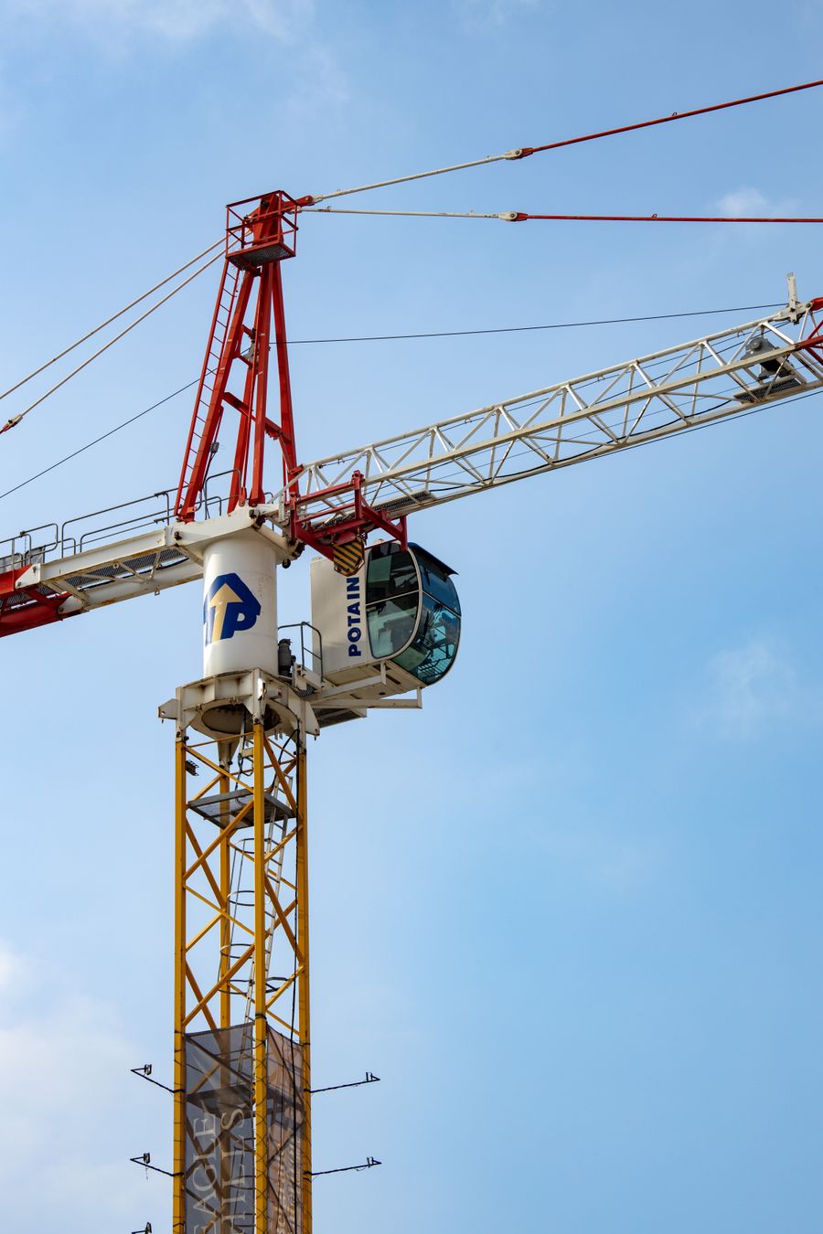 Flat-top tower crane against a blue sky
