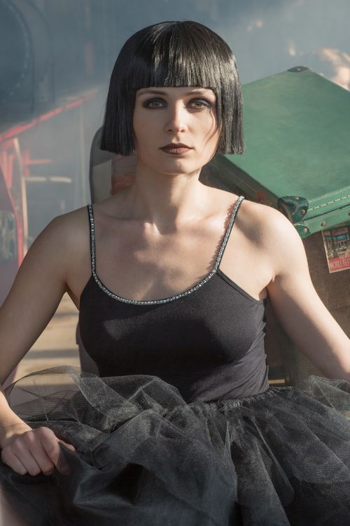 Free Elegant woman with a bob haircut wearing a black dress, embodying sophistication and style. Stock Photo