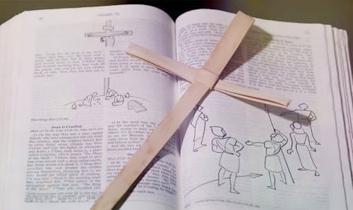 Paper Holy Cross on Opened Bible