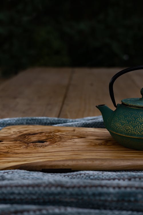 A Green Teapot on Wooden Table 