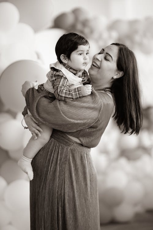 Woman Carrying a Toddler