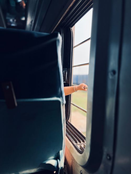 Free A hand extends from a moving train window, suggesting freedom and travel. Stock Photo