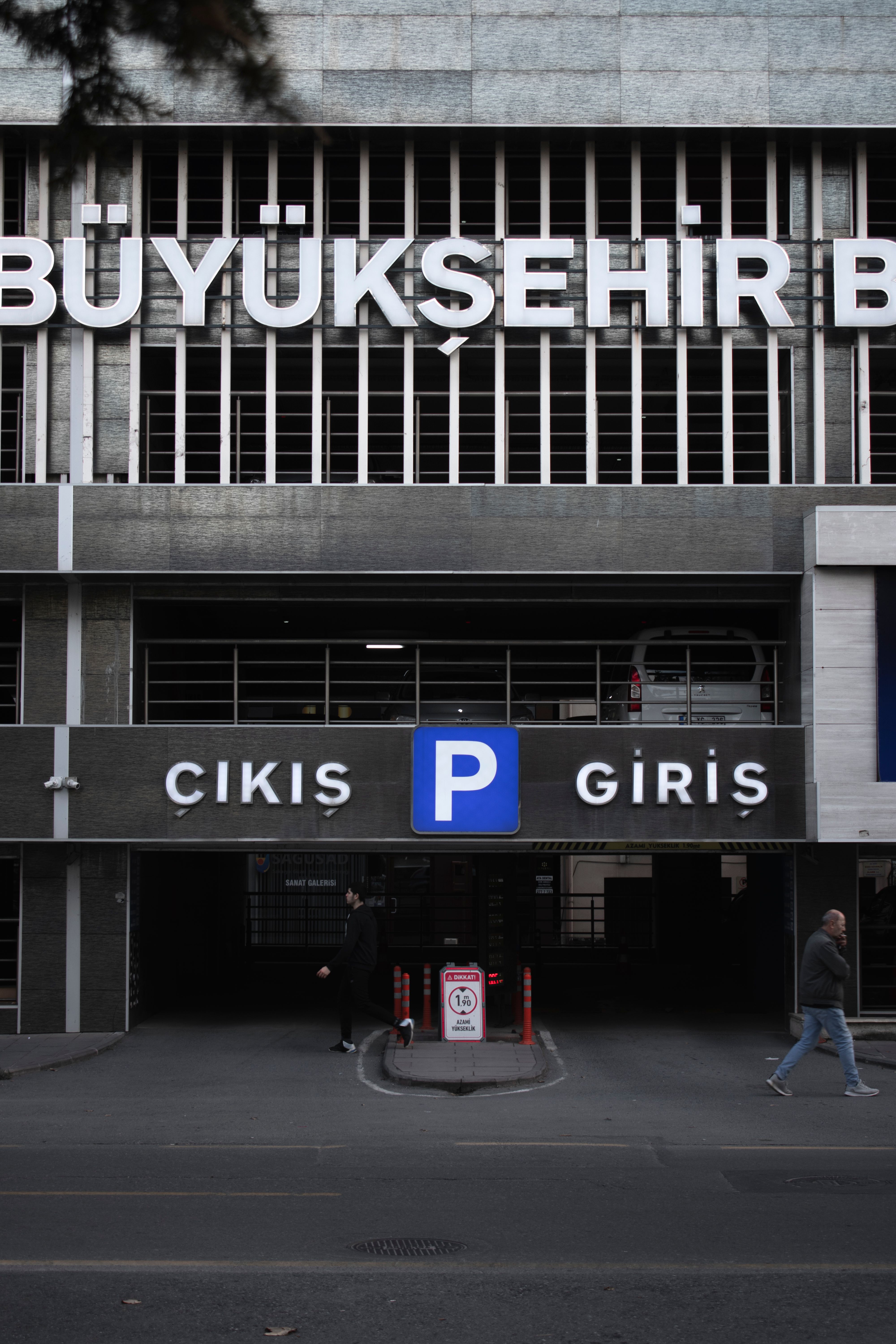 Street-level perspective of a modern city parking garage entrance with Turkish signage.