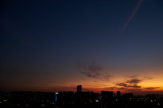 A breathtaking view of a city skyline at twilight with vibrant colors in the sky.
