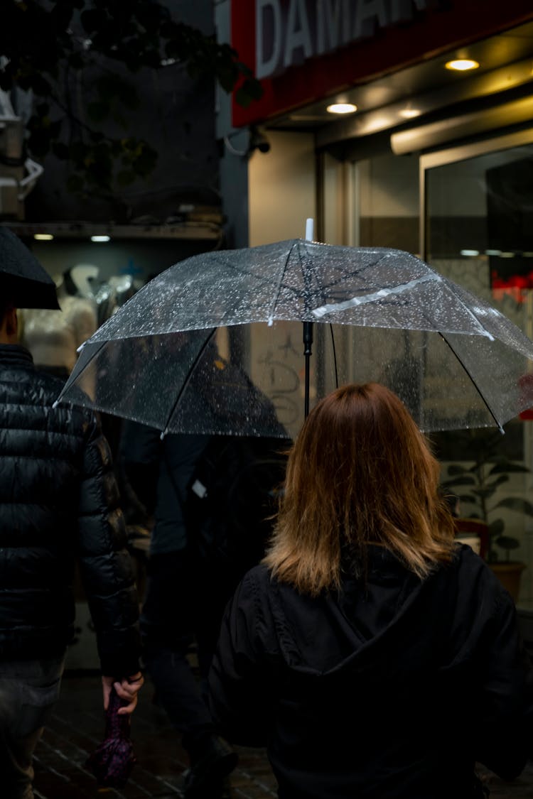 Back View Of A Woman With Clear Umbrella