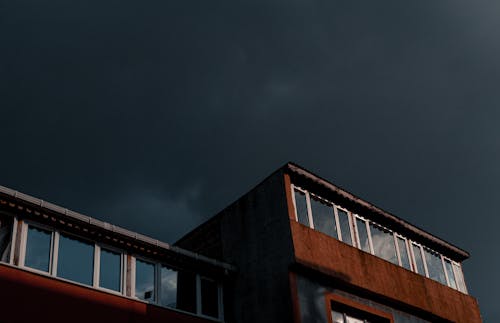 Brown Concrete Building Under Gray Sky