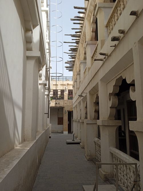 Free A narrow alley showcasing the traditional architecture of Souq Waqif in Doha, Qatar. Stock Photo