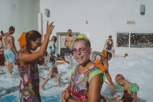 People on Holidays Having a Fun in Foam