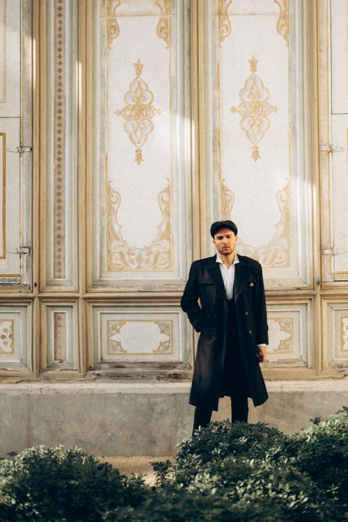 Free A fashionable man in a trench coat poses by a decorative building in Istanbul, Turkey. Stock Photo