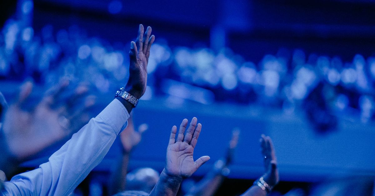 Christ Embassy Ho Friday night worship atmosphere with raised hands