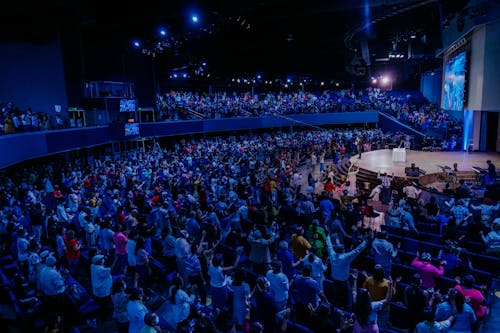 Audience Standing in an Auditorium during an Event 