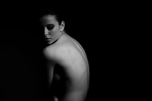 Topless Woman Inside Dark Room