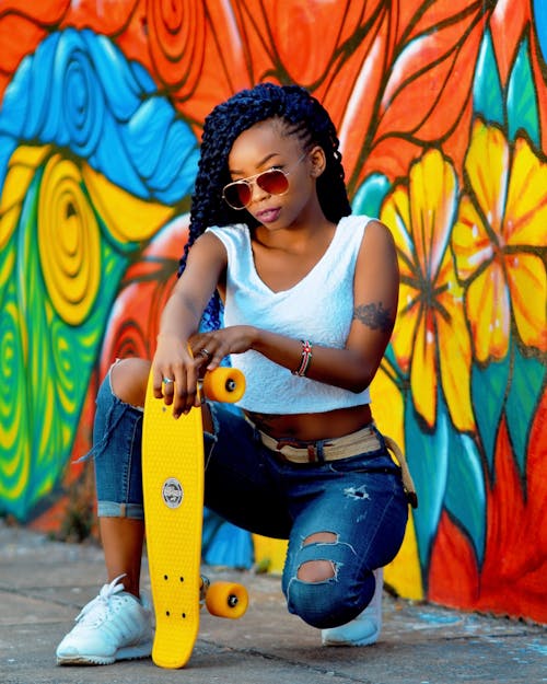 Beautiful Woman Posing with Yellow Skateboard