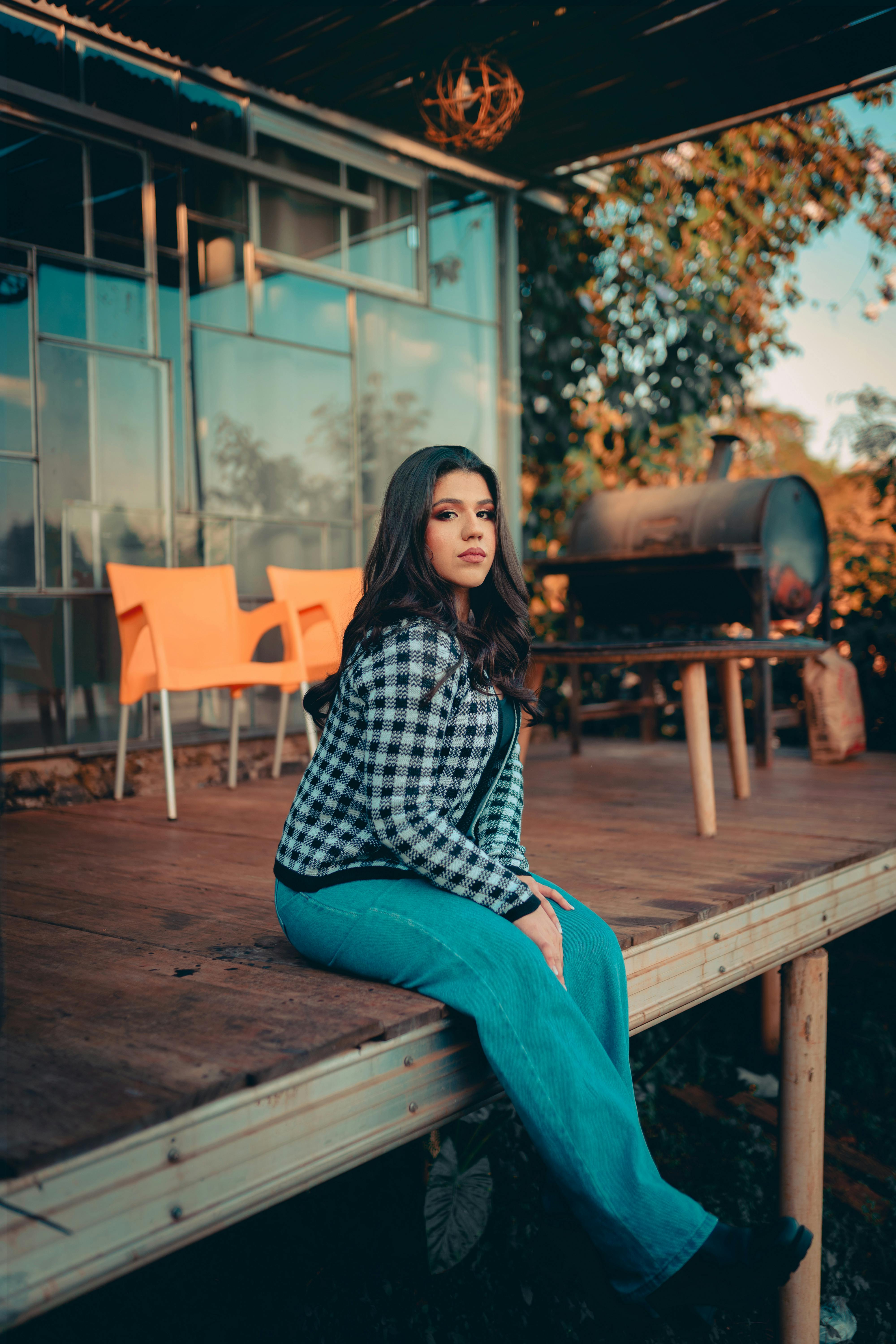 young woman sitting on a wooden porch