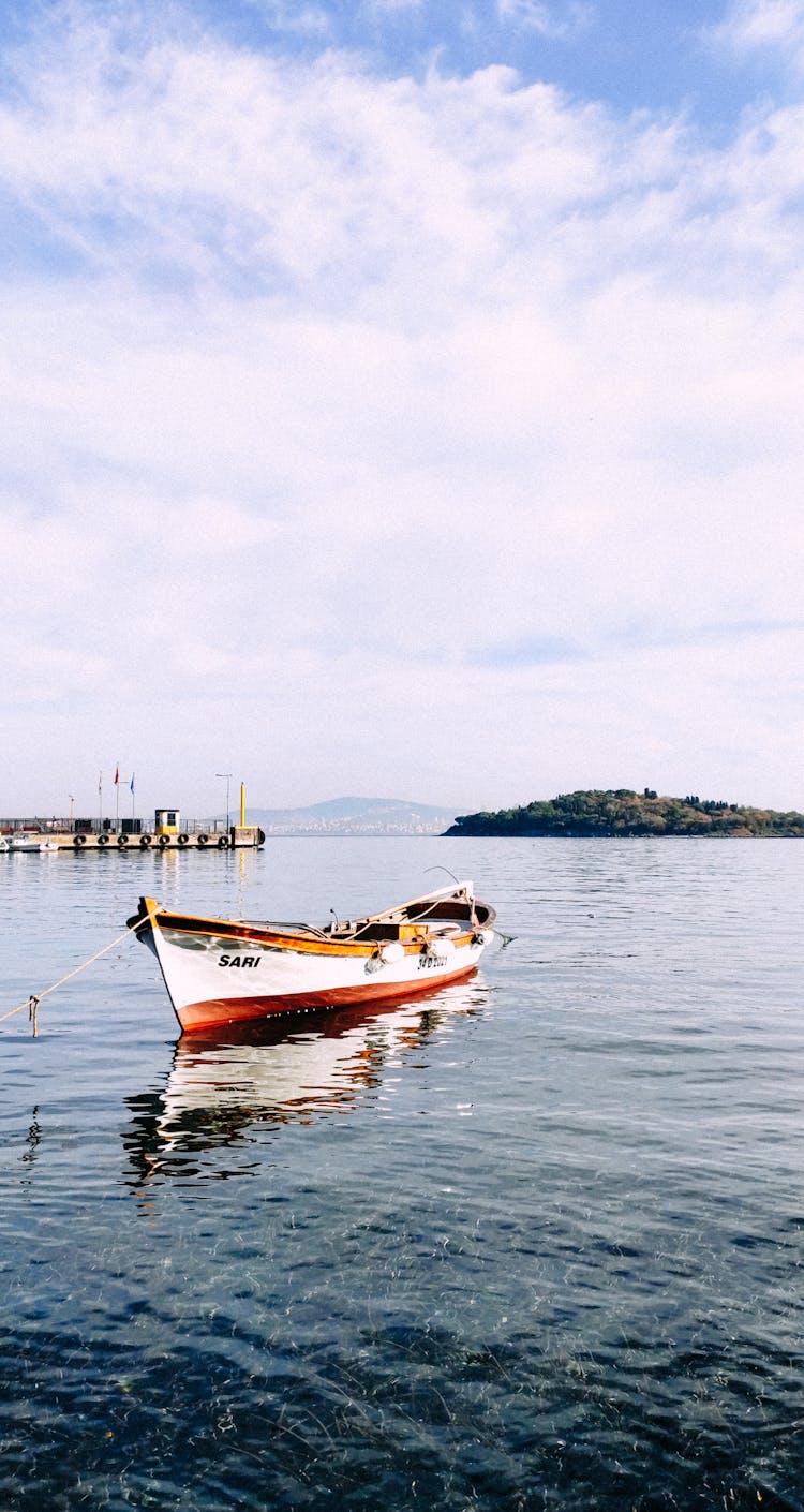 Red And White Boat On Sea