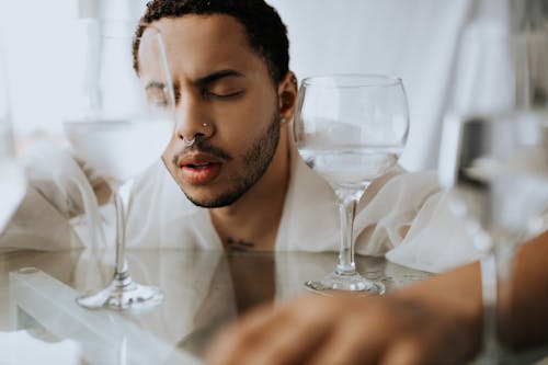 Man with Eyes Closed near Glasses