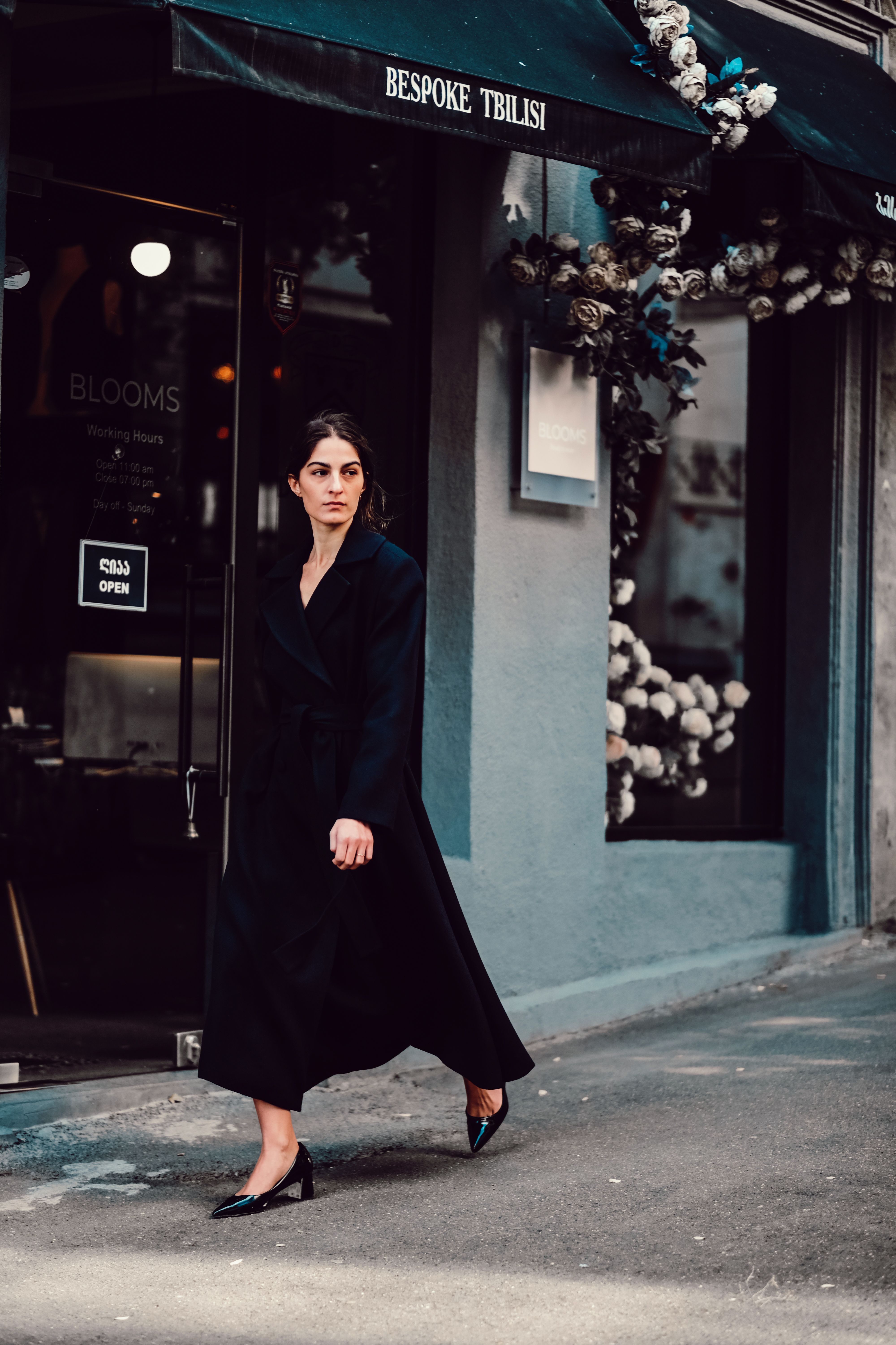 A Woman in a Black Coat Walking on a Street · Free Stock Photo