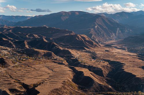 Free Stunning aerial view of a dry, mountainous landscape with scattered villages. Stock Photo