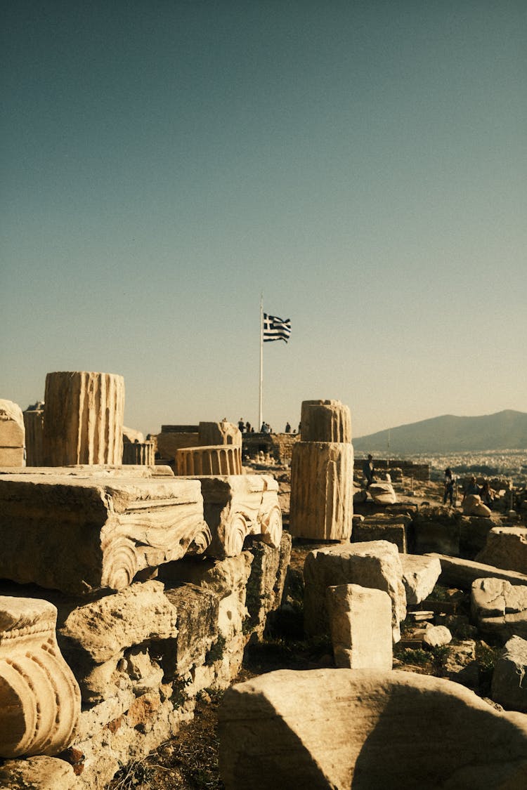 Greek Flag In The Ruins, Acropolis Of Athens, Greece