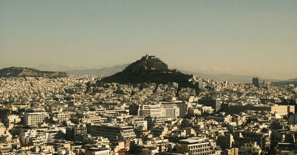Discover breathtaking Athens cityscape with Mount Lycabettus at sunrise.