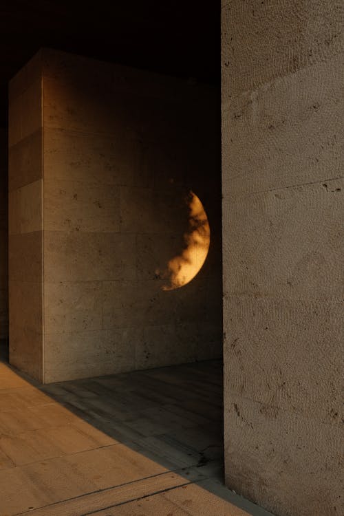 Crescent Light Between Two Bare Walls