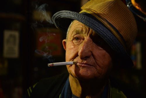 Man Wearing Brown Hat Smoking