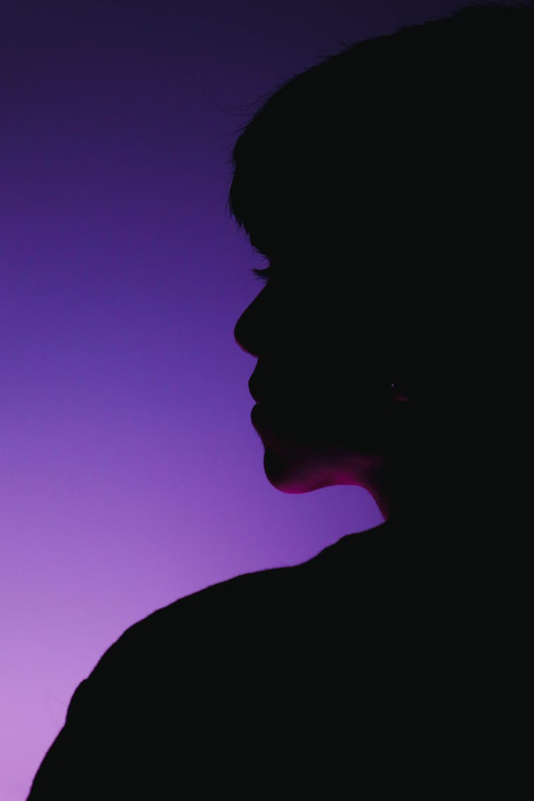 Woman Face Silhouette On Purple Background