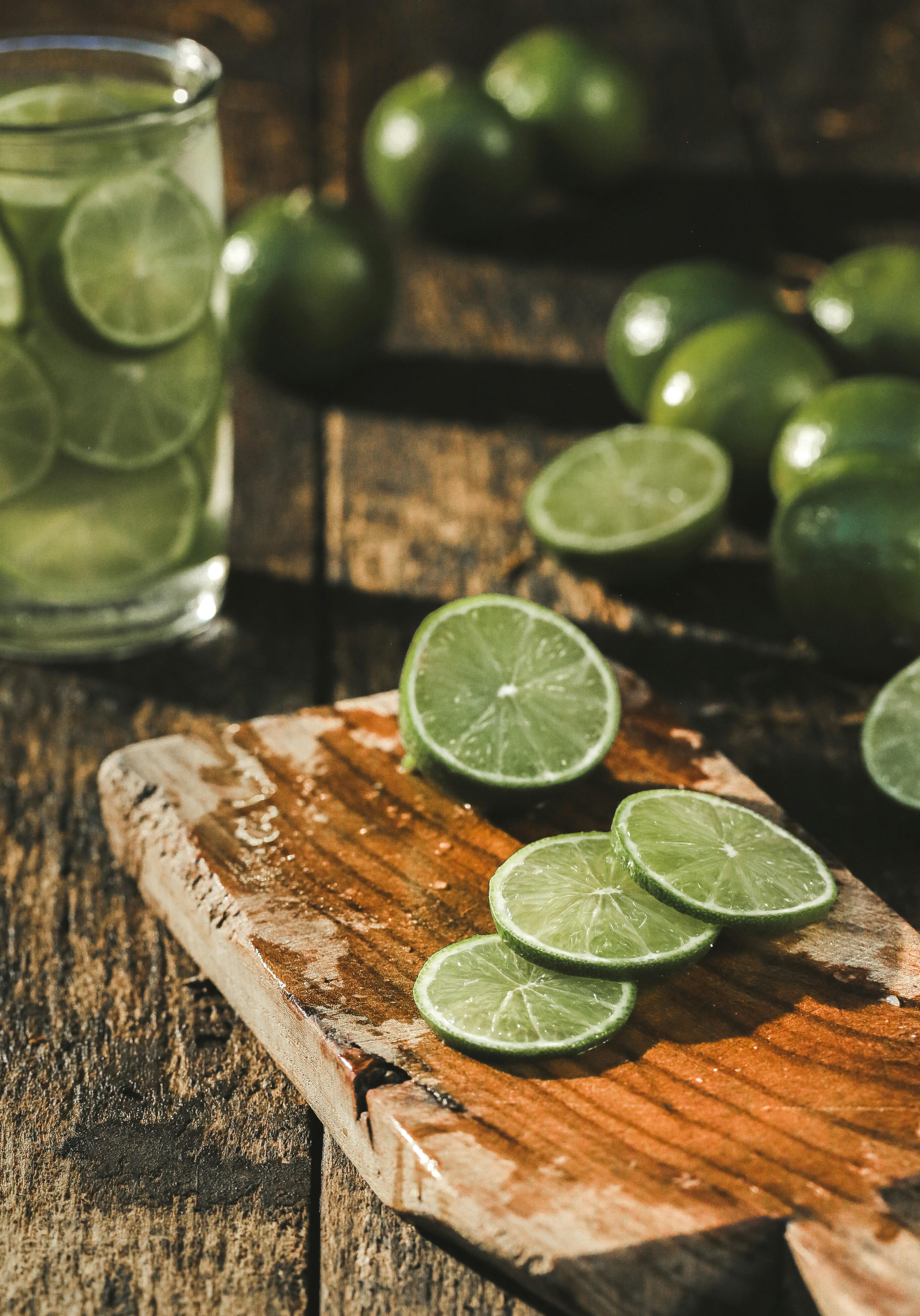 Slice of Limes on Brown Wood Chopper