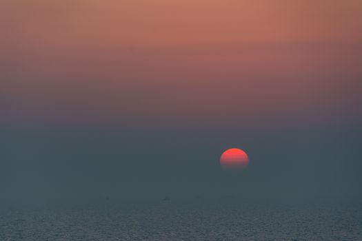 A captivating view of the sun setting over tranquil waters, creating a serene atmosphere.