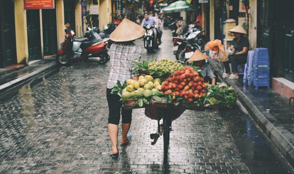 A woman sells fresh fruits in a Đống Đa street market, Hanoi, Vietnam.