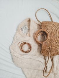 Flat lay of a knit sweater with a woven bag — photo by A.V. Phina on Pexels