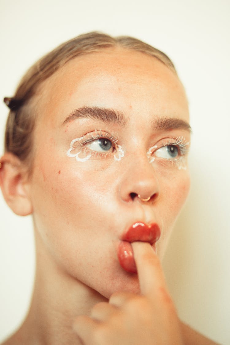 Close-up Of A Woman Biting Finger