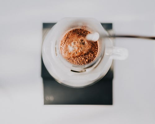 Free Top View of a Water being Poured into a Cup with a Coffee Filter  Stock Photo