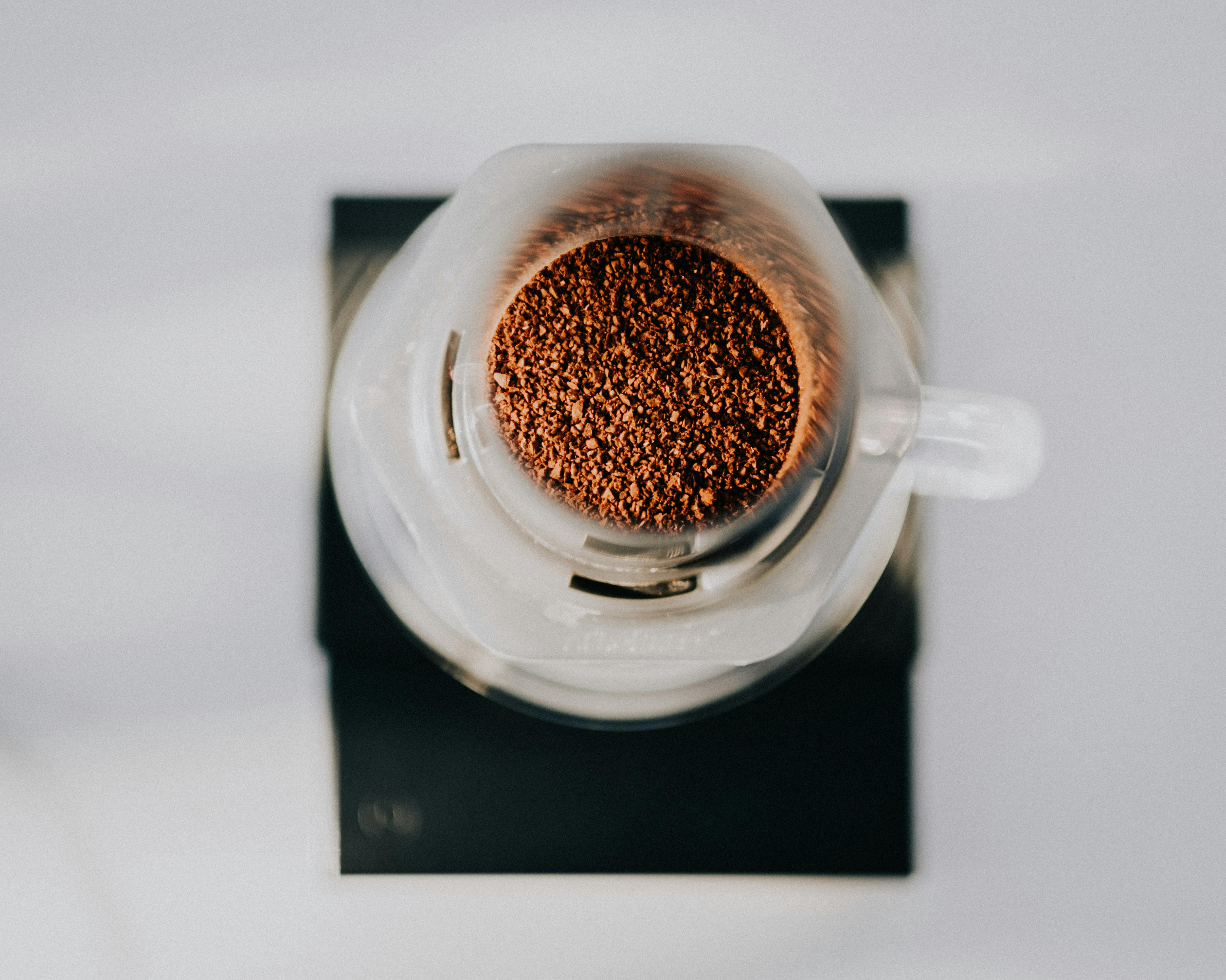 Top-down view of fresh coffee grounds in a glass brewing device in Türkiye.