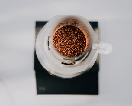Top-down view of fresh coffee grounds in a glass brewing device in Türkiye.