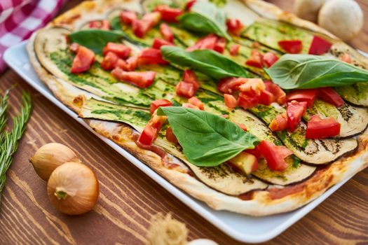 Delicious vegetable pizza featuring fresh eggplant, basil, and tomatoes for a healthy meal.