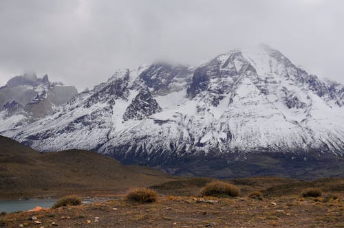 Snow Covered Mountain Under White Sky