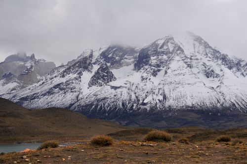 Free Scenic view of snow-capped mountains under cloudy skies in winter. Stock Photo