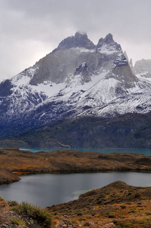 Free Breathtaking view of snow-covered mountains and tranquil lake in a stunning winter landscape. Stock Photo