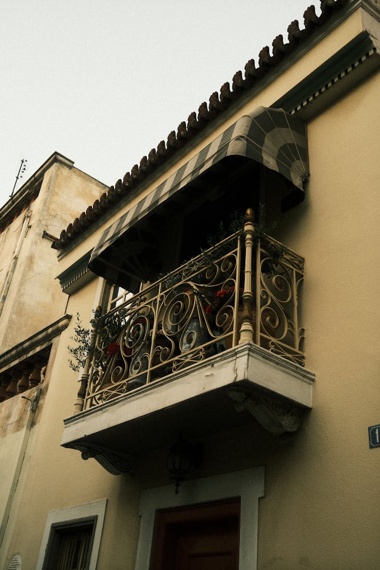 Balcony With Flowers On Building