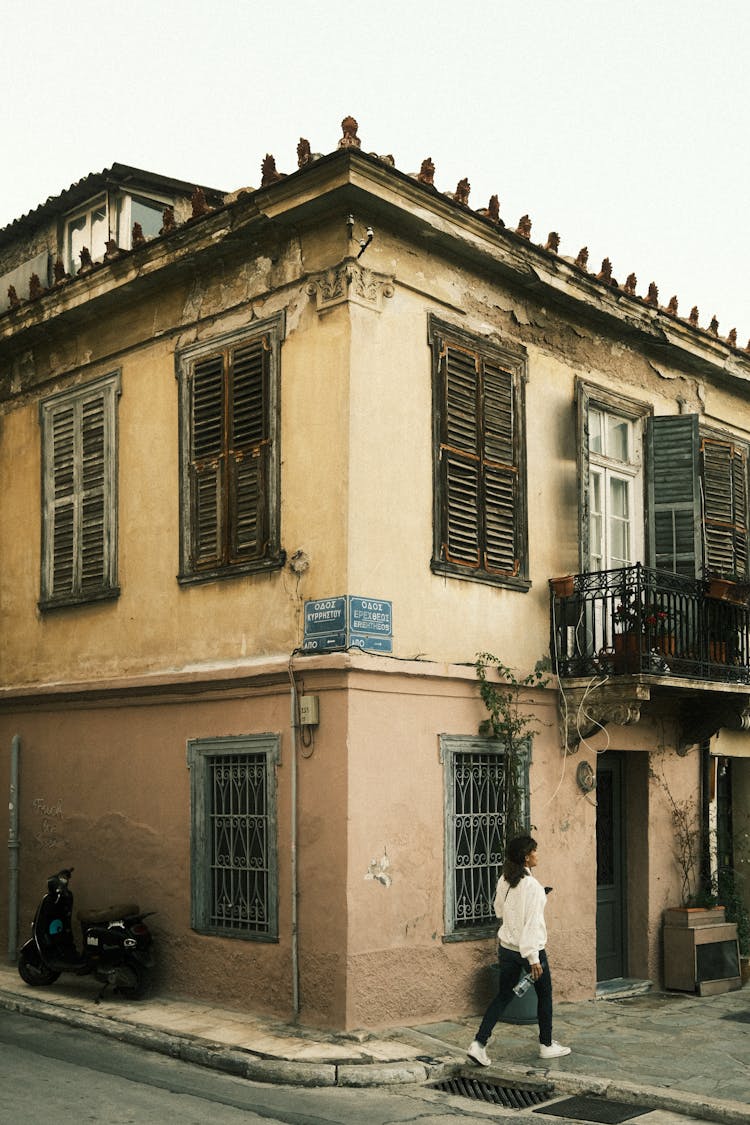 Traditional House With Shutters On Town Street