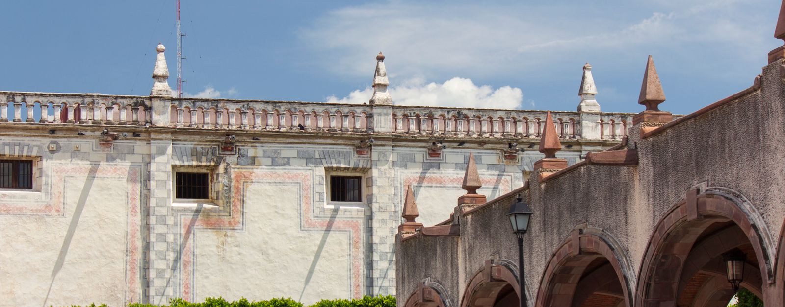 Beautiful arches and historic architecture in Santiago de Querétaro, Mexico under a clear blue sky.