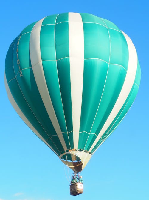 Flight in a Green Hot Air Balloon with White Stripes