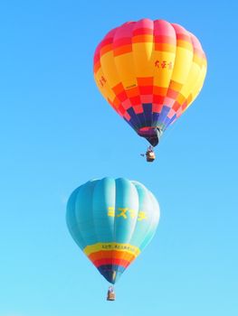 Vibrant hot air balloons float against a clear blue sky, capturing the spirit of adventure.