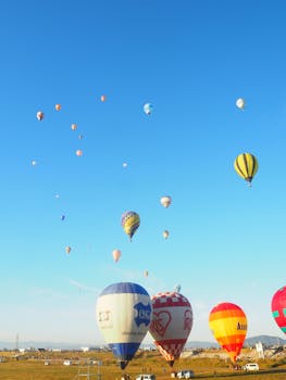 A vibrant scene of numerous hot air balloons floating in a clear blue sky, capturing an adventure in midair.