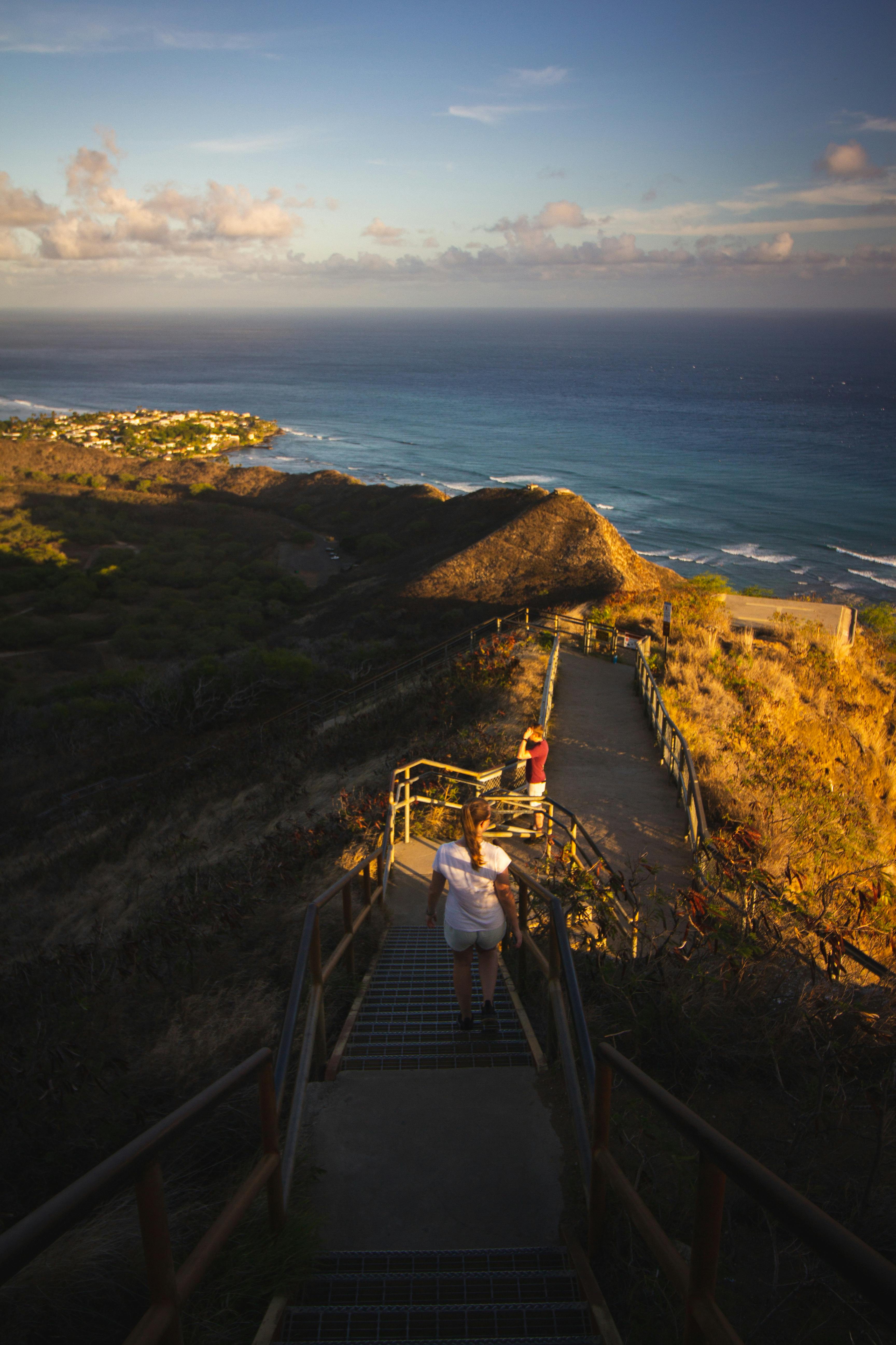 hikers on the seaside trail at sunset