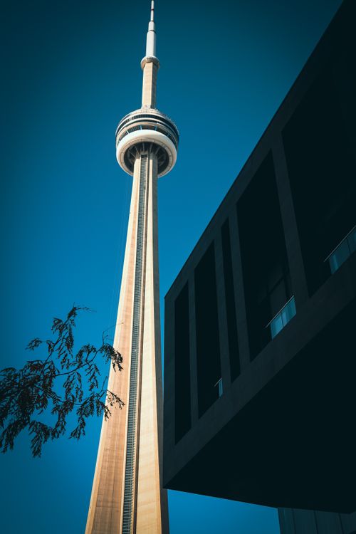 Free Dramatic low angle view of Toronto's CN Tower with modern architecture. Stock Photo