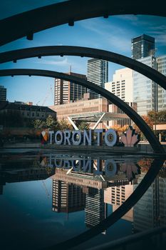 Beautiful view of Toronto's arches and skyline reflected in a downtown pond.