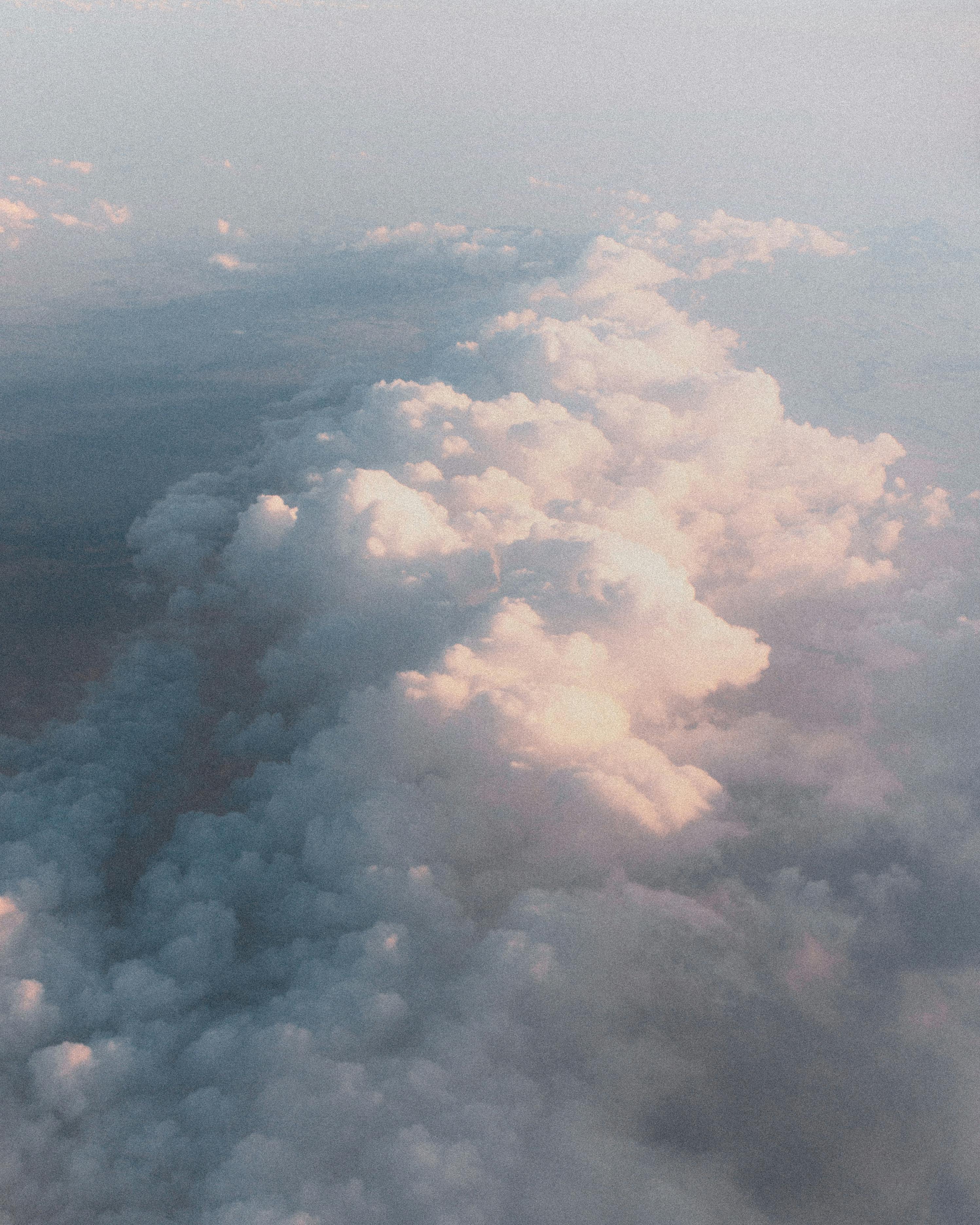 Beautiful pastel cloudscape observed from an airplane, capturing nature's serene beauty from above.