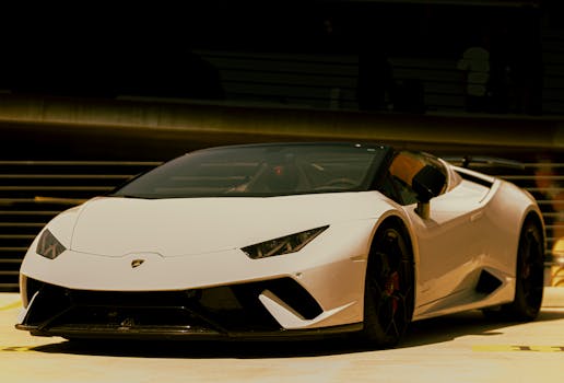 Front view of a stylish white Lamborghini parked outdoors, showcasing luxury and elegance.